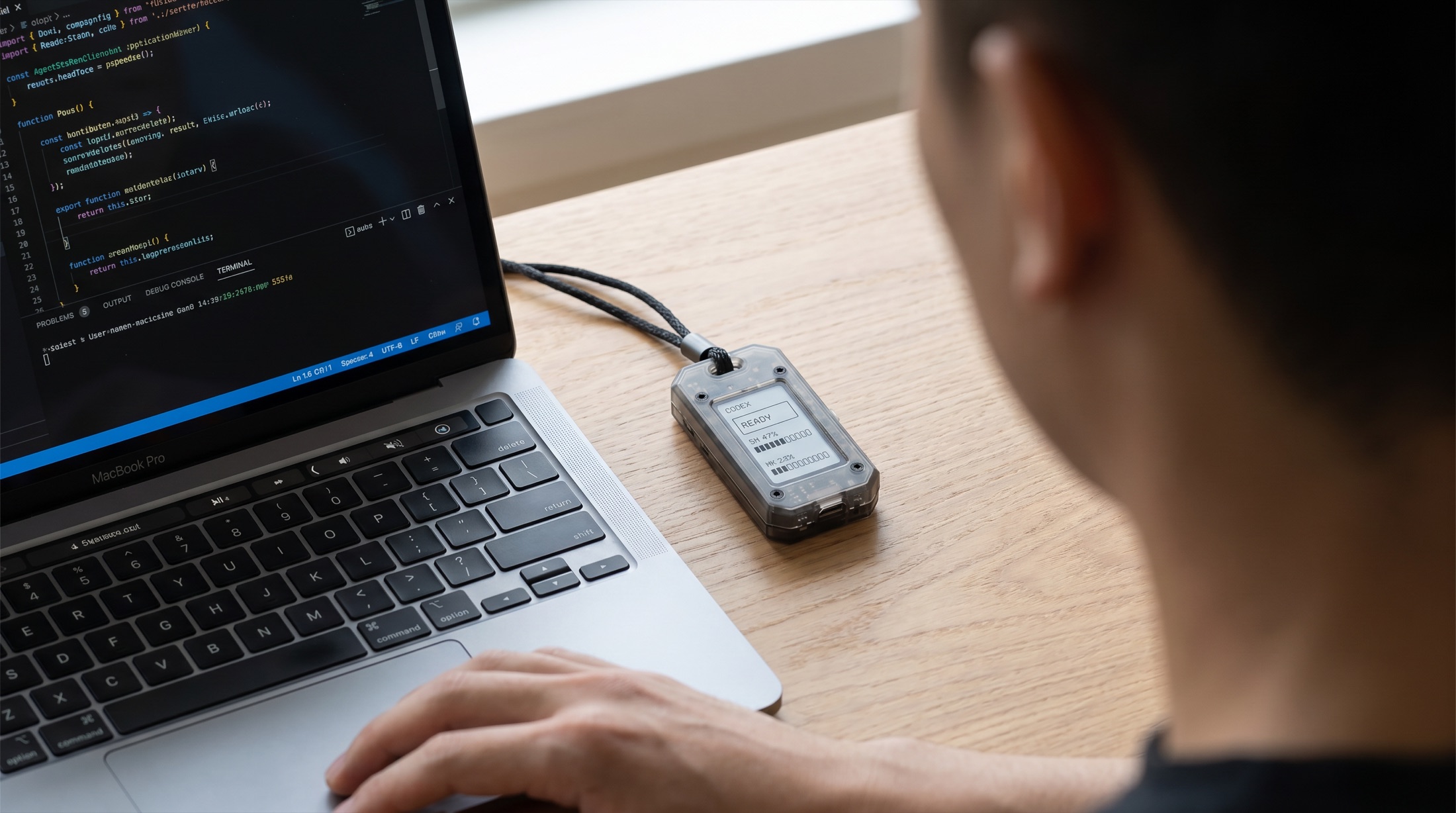 Agent Battery beside a laptop during a coding session